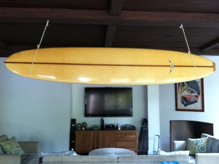 Hung surfboard from rafter with heavy twine/rope.
